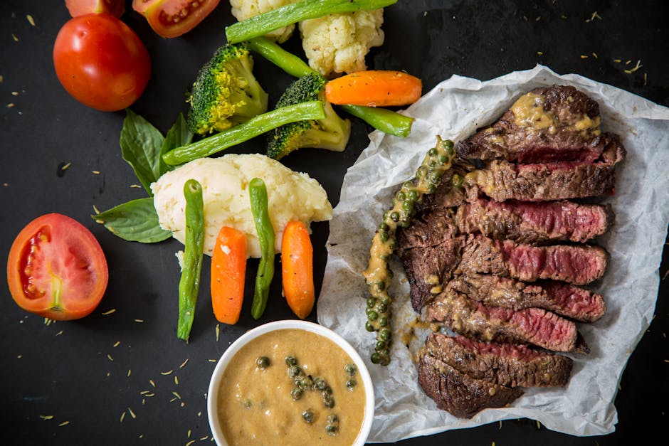 Grilled steak served with fresh vegetables and pepper sauce