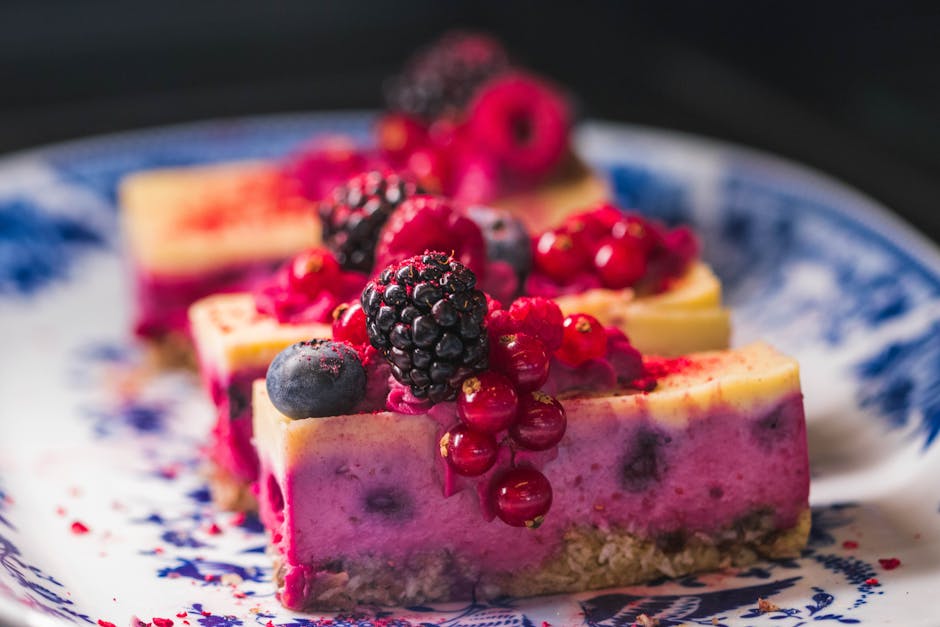 Sliced berry cheesecake topped with vibrant fresh berries